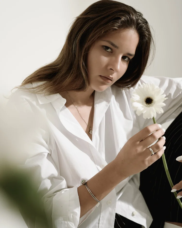 Fashion portrait holding a daisy